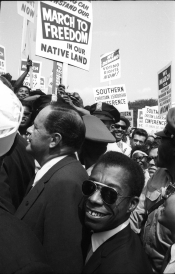 Joseph Mankiewicz and James Baldwin merging with the crowd © Dan Budnik, All Rights Reserved